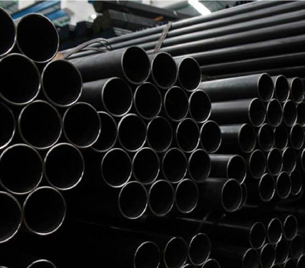 Stacked black steel pipes for industrial use